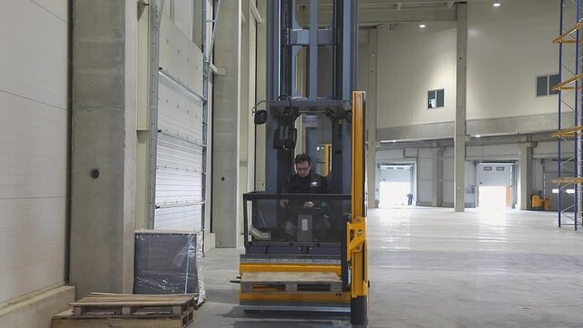 New Forklift Truck Stacker With Pallet in Empty Warehouse