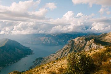 White cumulus clouds over the mountains near the Bay of Kotor. Mount Lovcen