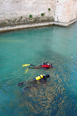 Scuba divers workers underwater archaeology works. Lake underwater archaeological survey works in...
