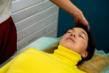 A young woman practices the technique of kinesiology. Chiropractic treatment, Back pain relief....