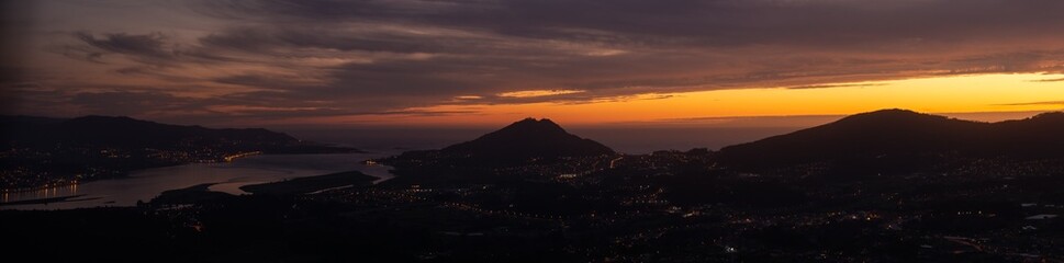 Panoramic view of the miño river, the mountain Santa Tecla and the towns of the Rosal and A Guarda from the "niño do corvo" viewpoint at night.