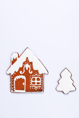 The hand-made eatable gingerbread house and New Year Tree on white background - 468669695