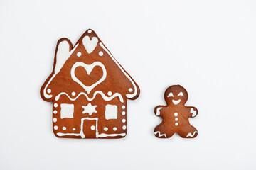 The hand-made eatable gingerbread house and little man on white background - 468669696