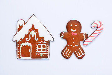 The hand-made eatable gingerbread house, little man with caramel on blue background - 468669697