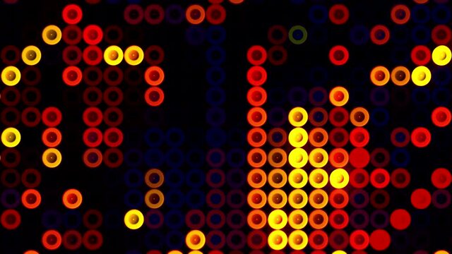 Old school pixels animation flickering on black background. Motion. Colorful running circle snakes, design of retro game for children.