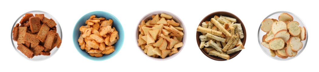 Set with different delicious crispy rusks on white background, top view. Banner design