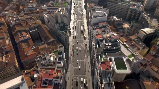 Top down view of busy street in Madrid tilts up to reveal city