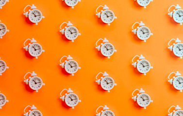 Minimal patter of a white clock over a orange bright background, copy space, minimal design, limited time offer concept, online ad timer, time and clock concepts