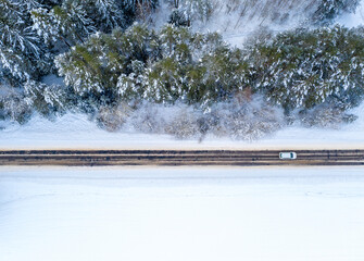 Aerial bird-eye view on freeway road in the winter forest