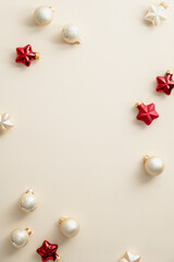 Fototapeta na wymiar Christmas composition with beige balls and red Xmas decorations on beige background. Christmas social media vertical banner design, poster, greeting card.