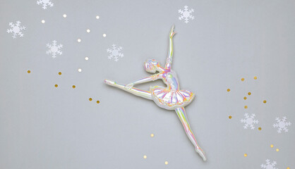 pearlescent toy ballerina and snowflakes, christmas background for congratulations to dancers or...