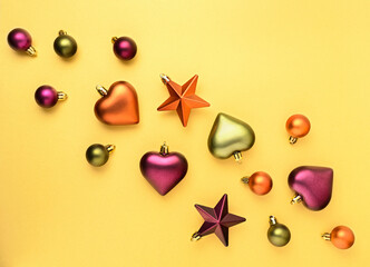 Bright Christmas pattern with balls, stars and hearts on gold background. Flat lay, banner format