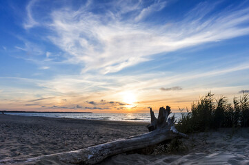 Sunset over the sea. Reflection of sunlight in the sea waves. The sky in the sunset rays.