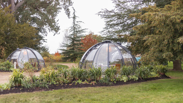 Outdoor glass dome dining pods in autumn