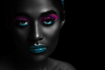 Stylized portrait of a beautiful girl with neon makeup close-up