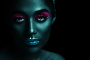 Poster Stylized portrait of a beautiful girl with neon makeup close-up © smiltena