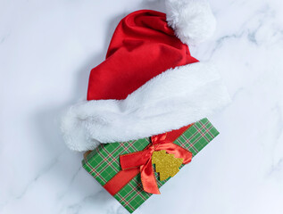 Christmas gift boxes with Santa Claus hat on white background