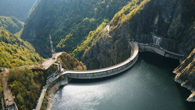 Aerial drone view of nature in Romania. Valley in Carpathian mountains with Vidraru dam and lake, slopes with lush forest