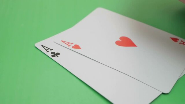 Two aces in the hands of a professional poker player. The poker player checks his cards before increasing the bet. The professional poker player has two aces.Concept of gambling. The professional