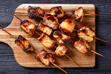 Juicy grilled pork kebabs on a cutting board