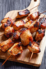 Juicy grilled pork kebabs on a cutting board