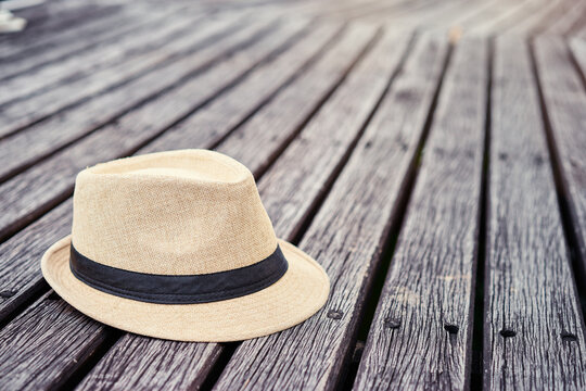 Accessory for travel. Hat on the wooden background.