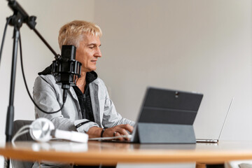 The radio host transmits the news in the morning. The journalist is an adult gray-haired man....