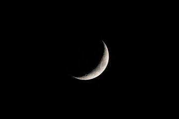 Fototapeta na wymiar Crescent moon over clear night sky