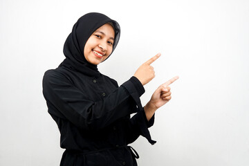 Beautiful young asian muslim woman smiling confident, enthusiastic and cheerful with hands pointing empty space presenting something facing camera isolated on white background, advertising concept