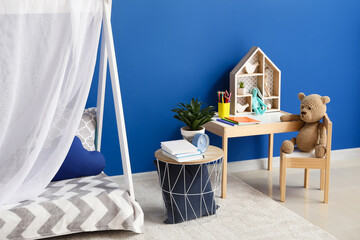 Stylish interior of modern children's room with blue wall © Pixel-Shot