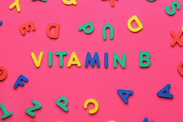 Text VITAMIN B with letters on color background
