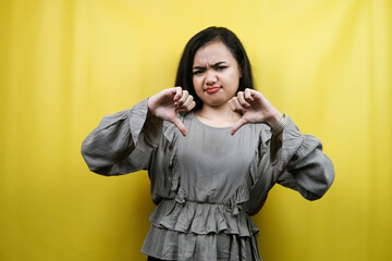 Beautiful young woman with dislike hand, thumbs down, isolated