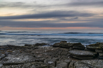 Sunrise seascape with rocky foreground