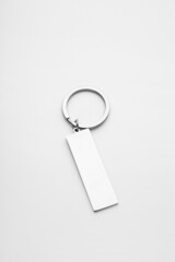 Stylish steel keychain on light background