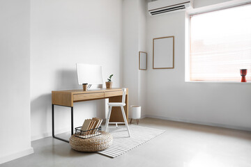 Interior of light stylish room with workplace