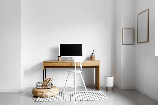 Interior of light stylish room with workplace