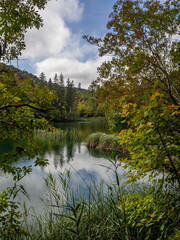 Reflection of mountains and trees in lake within the Plitvice Lakes District, Croatia. 