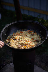 Summer vacation in the backyard cooking delicious pilaf outdoors