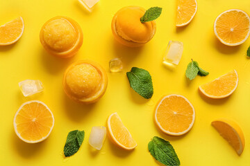 Tasty ice creams in orange peels on color background