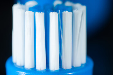 Clean and new toothbrush close-up on a dark background, macro photography