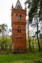 Fototapeta na wymiar Old brick water tower in Natalyevka park in Kharkiv region, Ukraine