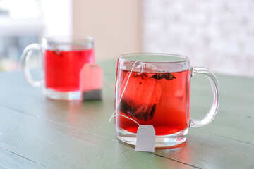 Glass cups of hot tea on table in cafe