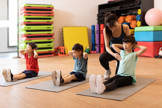 Cute children having exercise class in gym