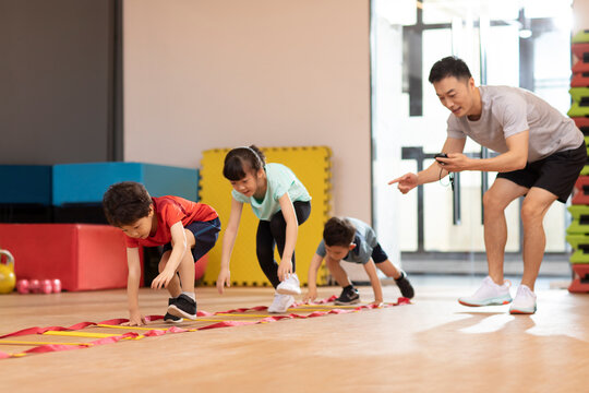 Cute children having exercise class in gym