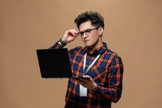 Young Chinese man working with laptop