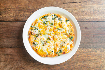 spinach and bacon pizza on plate