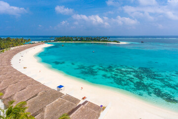 An aerial view on the tropical white sand beach on a Maldivian island in Indian Ocean