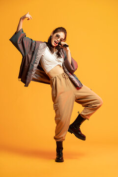 Studio shot of fashionable young woman singing