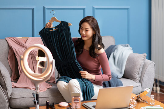 Young Chinese woman doing live webcast at home