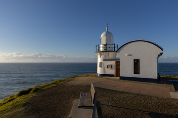 Fototapeta na wymiar tacking point lighthouse and bench on an autumn morning at port macquarie